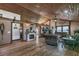 Inviting living room featuring a stunning wooden ceiling, stone fireplace, and comfortable seating arrangement at 4292 Sw 73Rd Trl, Bushnell, FL 33513