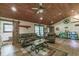 Comfortable living room featuring a cozy seating area, wooden ceiling, and a sliding barn door accent at 4292 Sw 73Rd Trl, Bushnell, FL 33513