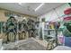 The tack room has saddles on saddle stands and storage containers on shelving at 4292 Sw 73Rd Trl, Bushnell, FL 33513