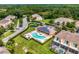 Aerial view of the community pool, playground, and surrounding townhomes at 17531 Placidity Ave, Clermont, FL 34714