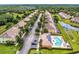 Aerial view of 17531 Placidity Ave, Clermont, FL 34714 with community pool, solar panels, and lush landscaping at 17531 Placidity Ave, Clermont, FL 34714