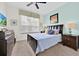Relaxing bedroom with a comfortable bed, dresser, and ceiling fan at 17531 Placidity Ave, Clermont, FL 34714
