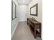 Inviting entryway with stylish console table, decor, tiled floor, and wall art at 17531 Placidity Ave, Clermont, FL 34714