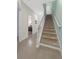 Hallway with staircase, tile flooring, neutral paint and access to bathroom at 17531 Placidity Ave, Clermont, FL 34714