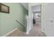 Upstairs hallway leading to bedroom with neutral paint and carpeted floors at 17531 Placidity Ave, Clermont, FL 34714