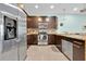 Modern kitchen with stainless steel appliances, dark cabinets, and granite countertops at 17531 Placidity Ave, Clermont, FL 34714