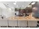 Modern kitchen with stainless steel appliances, granite countertops, and barstool seating at 17531 Placidity Ave, Clermont, FL 34714