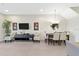 Open-concept living room and dining area with neutral tile flooring and contemporary decor at 17531 Placidity Ave, Clermont, FL 34714