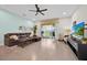 Living room with leather sofa, tile flooring, and sliding glass doors to the outdoor patio at 17531 Placidity Ave, Clermont, FL 34714