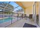Screened patio area featuring tile floors, dining furniture, and pool access at 17531 Placidity Ave, Clermont, FL 34714
