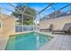 Private screened-in pool with lounge chairs at 17531 Placidity Ave, Clermont, FL 34714