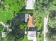 Aerial view of a quaint home showcasing a well-maintained lawn and mature trees at 5337 Jacob Ave, Polk City, FL 33868