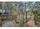 Lush backyard view showcasing a custom pool deck and bridge for waterfront access at 8847 Rose Hill Dr, Orlando, FL 32818
