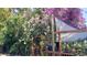 Picturesque backyard with blooming flowers, lush greenery, and a cozy deck area at 8847 Rose Hill Dr, Orlando, FL 32818