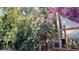Picturesque backyard with blooming flowers, lush greenery, and a cozy deck area at 8847 Rose Hill Dr, Orlando, FL 32818