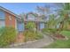 Inviting single-story home with a landscaped garden featuring a water feature and stone pathway at 8847 Rose Hill Dr, Orlando, FL 32818