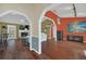 Open hallway connecting to living spaces, showcasing the home's hardwood flooring and bright interior at 8847 Rose Hill Dr, Orlando, FL 32818