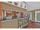 Modern kitchen with stainless appliances, breakfast bar, and hardwood floors at 8847 Rose Hill Dr, Orlando, FL 32818