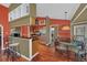 Open kitchen and dining area with stainless steel appliances and hardwood floors at 8847 Rose Hill Dr, Orlando, FL 32818