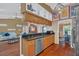 Charming kitchen with hardwood floors, wooden cabinetry, granite countertops, and stainless-steel appliances at 8847 Rose Hill Dr, Orlando, FL 32818