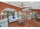 Inviting living room featuring vaulted ceilings, hardwood floors and an open layout leading to the kitchen at 8847 Rose Hill Dr, Orlando, FL 32818