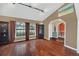 Well-lit living room featuring wood floors, neutral walls, and arched doorways at 8847 Rose Hill Dr, Orlando, FL 32818