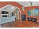Inviting living room with hardwood floors, a fireplace, and a vaulted ceiling with skylight at 8847 Rose Hill Dr, Orlando, FL 32818