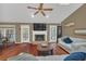 Cozy living room with fireplace, ceiling fan and wood floors at 8847 Rose Hill Dr, Orlando, FL 32818