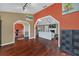 Spacious open-concept living room with hardwood floors and seamless transition to dining and kitchen areas at 8847 Rose Hill Dr, Orlando, FL 32818