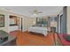 Main bedroom with hardwood floors and a large window, next to the main bathroom at 8847 Rose Hill Dr, Orlando, FL 32818