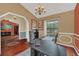 Home office featuring a large desk, chandelier lighting, wood floors, and neutral colored walls at 8847 Rose Hill Dr, Orlando, FL 32818