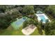 Aerial view showcasing a tennis court and a sparkling community pool at 7036 Mapperton Dr, Windermere, FL 34786