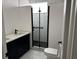 Modern bathroom featuring black fixtures, shower with a glass door, and double sink vanity at 7036 Mapperton Dr, Windermere, FL 34786