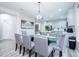 Open dining area features modern lighting, seating for eight, and flows into the kitchen for easy entertaining at 7036 Mapperton Dr, Windermere, FL 34786