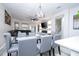 Open dining area features modern lighting, seating for eight, and flows into the kitchen for easy entertaining at 7036 Mapperton Dr, Windermere, FL 34786