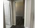 Hallway with wood-look floors leading to a bedroom with a door, providing privacy and style at 7036 Mapperton Dr, Windermere, FL 34786