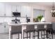 Well-lit kitchen island and breakfast bar with grey counter chairs at 7036 Mapperton Dr, Windermere, FL 34786