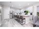Bright kitchen with island, breakfast bar, and stainless refrigerator at 7036 Mapperton Dr, Windermere, FL 34786