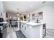 Kitchen island with sink and view of dining and living space at 7036 Mapperton Dr, Windermere, FL 34786