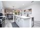 Kitchen island with sink and view of dining and living space at 7036 Mapperton Dr, Windermere, FL 34786