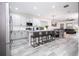 Spacious kitchen with island, breakfast bar, stainless appliances, and adjacent dining area at 7036 Mapperton Dr, Windermere, FL 34786