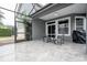 Screened lanai with tile flooring is perfect for outdoor dining and enjoying the backyard view at 7036 Mapperton Dr, Windermere, FL 34786
