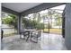 Screened lanai with tile flooring is perfect for outdoor dining and enjoying the backyard view at 7036 Mapperton Dr, Windermere, FL 34786