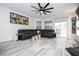 Spacious living room with large sectional sofa, fireplace, and built-in shelving for modern living at 7036 Mapperton Dr, Windermere, FL 34786