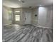 Bright and airy living room featuring modern gray flooring and neutral walls at 7036 Mapperton Dr, Windermere, FL 34786