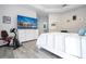 Bright main bedroom with tray ceiling, wood-look floors, and large television at 7036 Mapperton Dr, Windermere, FL 34786
