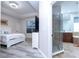 Spacious main bedroom featuring a tray ceiling, and an en-suite bathroom with glass enclosed shower and soaking tub at 7036 Mapperton Dr, Windermere, FL 34786
