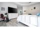 Bright main bedroom with tray ceiling, wood-look floors, and large television at 7036 Mapperton Dr, Windermere, FL 34786