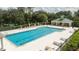 Inviting community pool with a spacious deck, lounge chairs and a convenient pool house at 7036 Mapperton Dr, Windermere, FL 34786