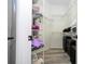 Walk-in closet with wire shelving, grey wood flooring, packed with clothes and luggage at 7036 Mapperton Dr, Windermere, FL 34786